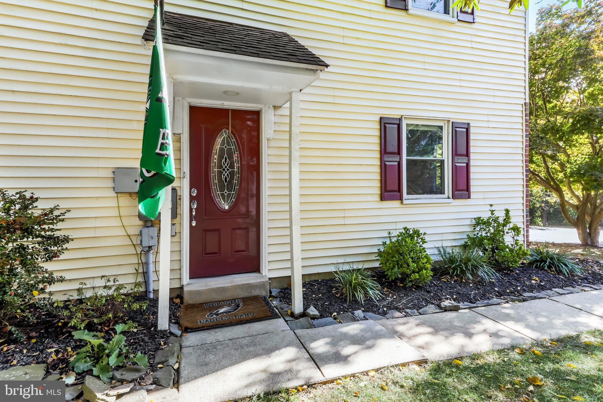 a front view of a house with potted plants