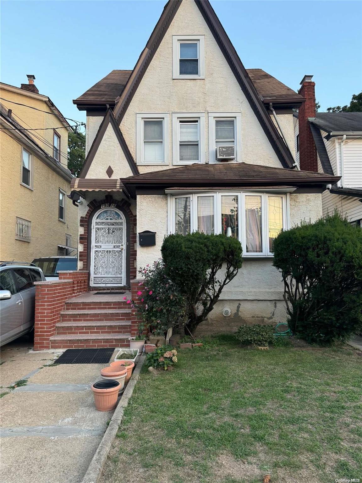 a front view of a house with garden