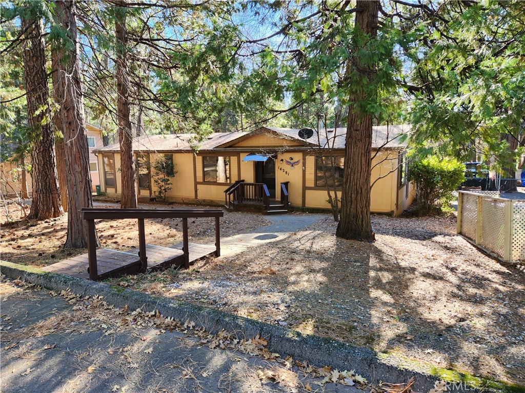 a front view of a house with a yard covered in snow