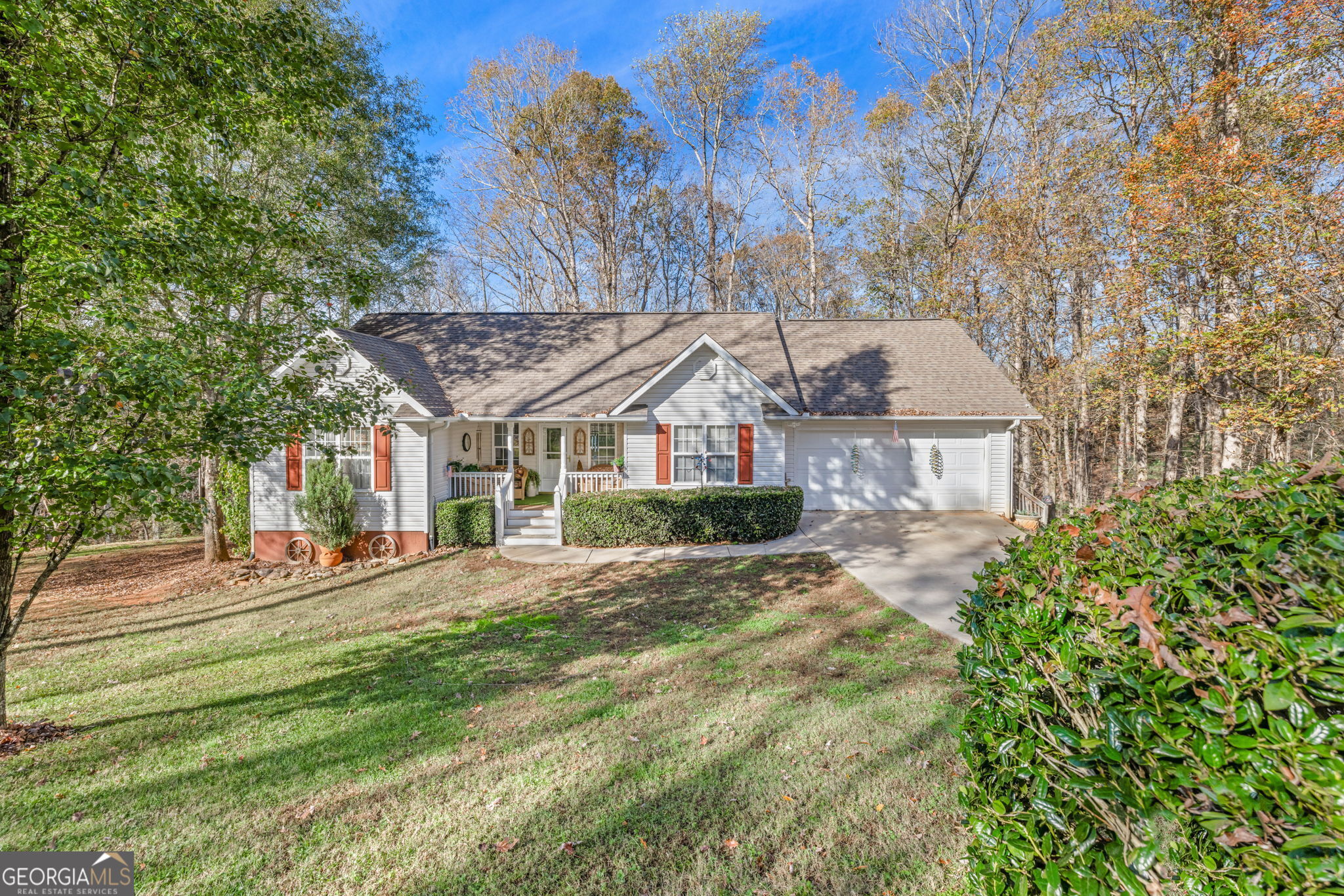 a view of a house with a yard and tree s