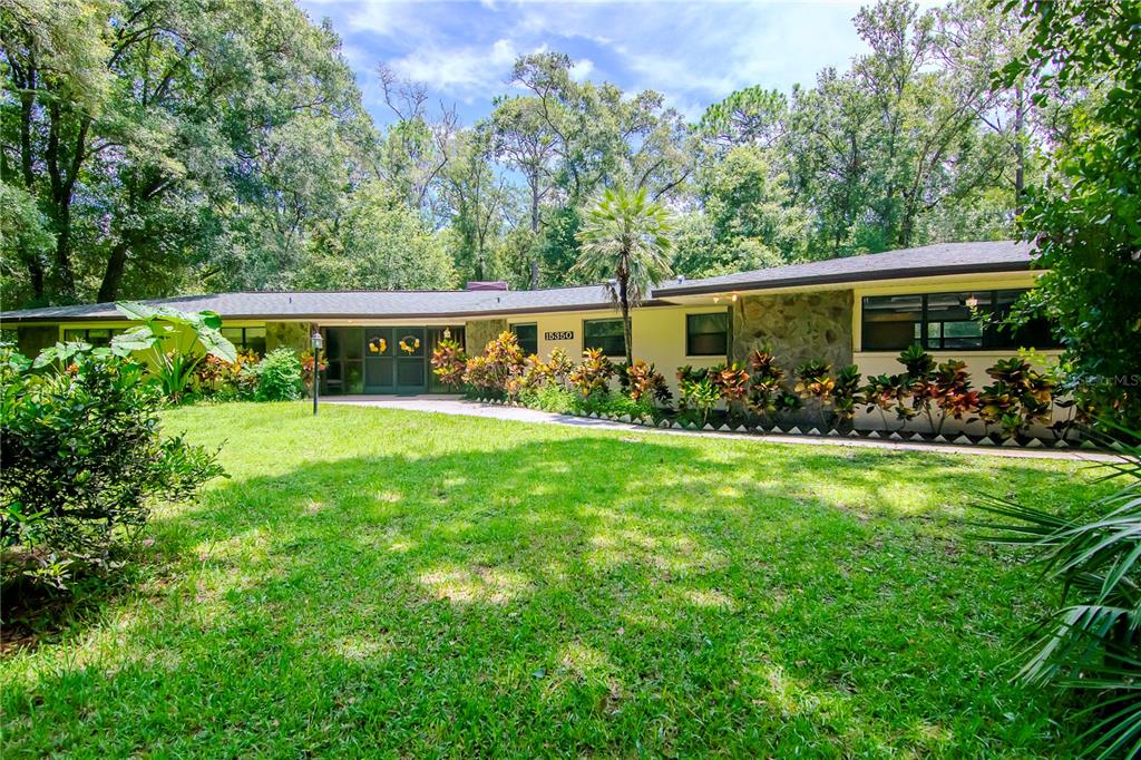 a view of an house with backyard space and garden