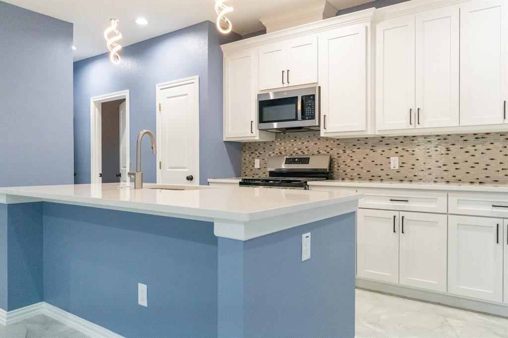 a kitchen with stainless steel appliances white cabinets and sink