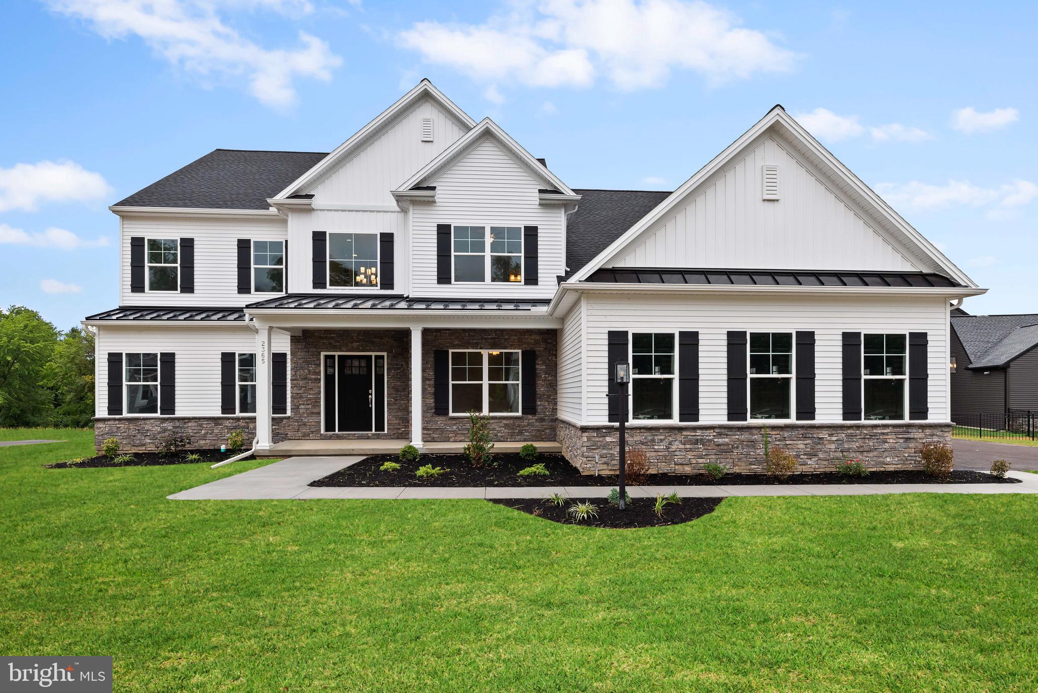 a front view of a house with a yard and outdoor seating