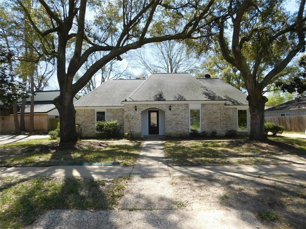 a house that has a tree in front of it