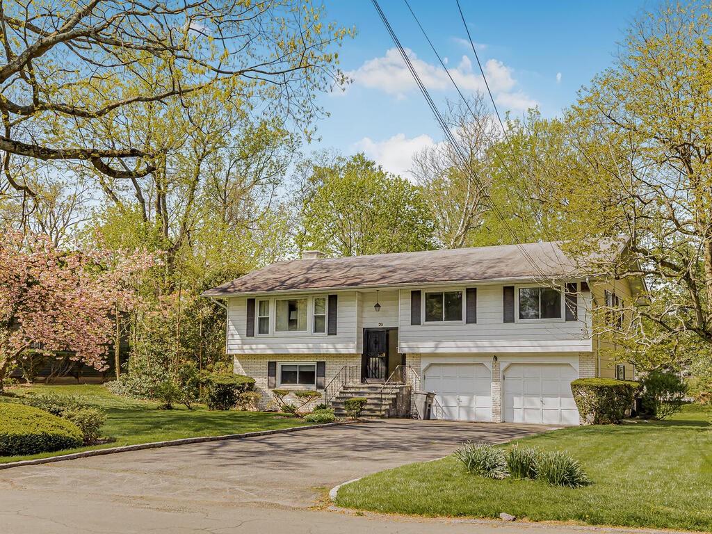 Bi-level home with a garage and a front lawn