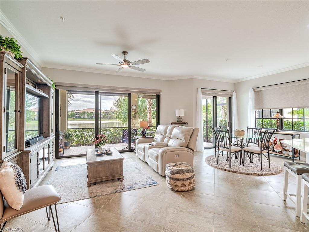 a living room with furniture and a large window with balcony view