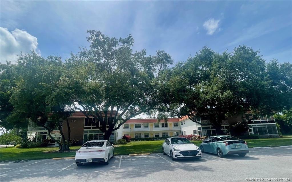 a car parked in front of house with a yard