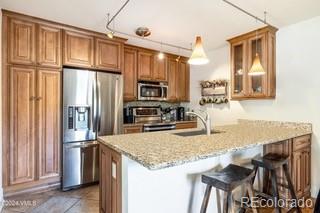 a kitchen with granite countertop a refrigerator a stove and a sink