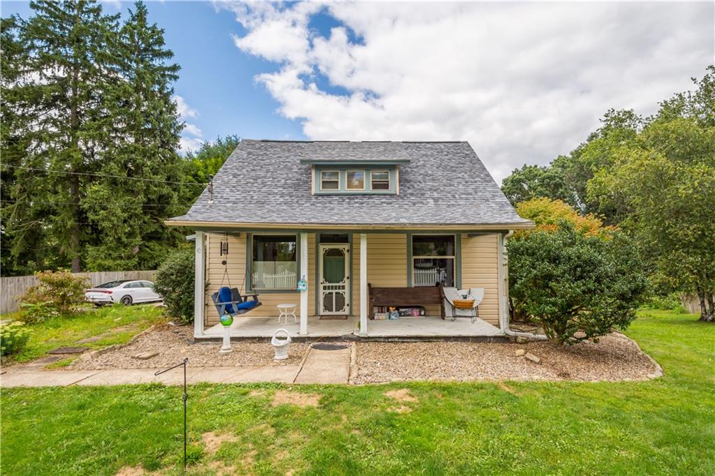 a view of a house with a yard patio and a garden