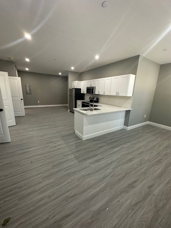 a view of kitchen with cabinets and wooden floor