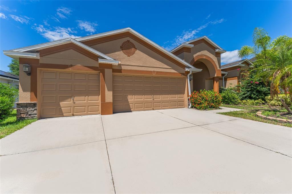 a front view of a house with a yard and garage