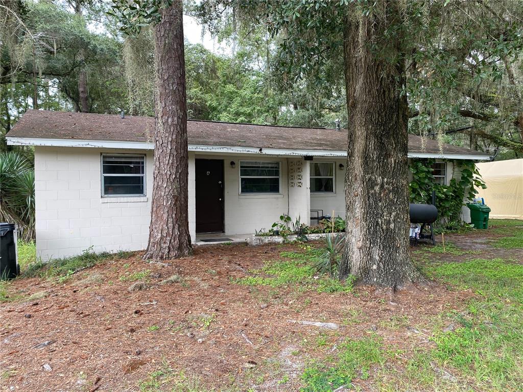 a view of house with outdoor space and garden