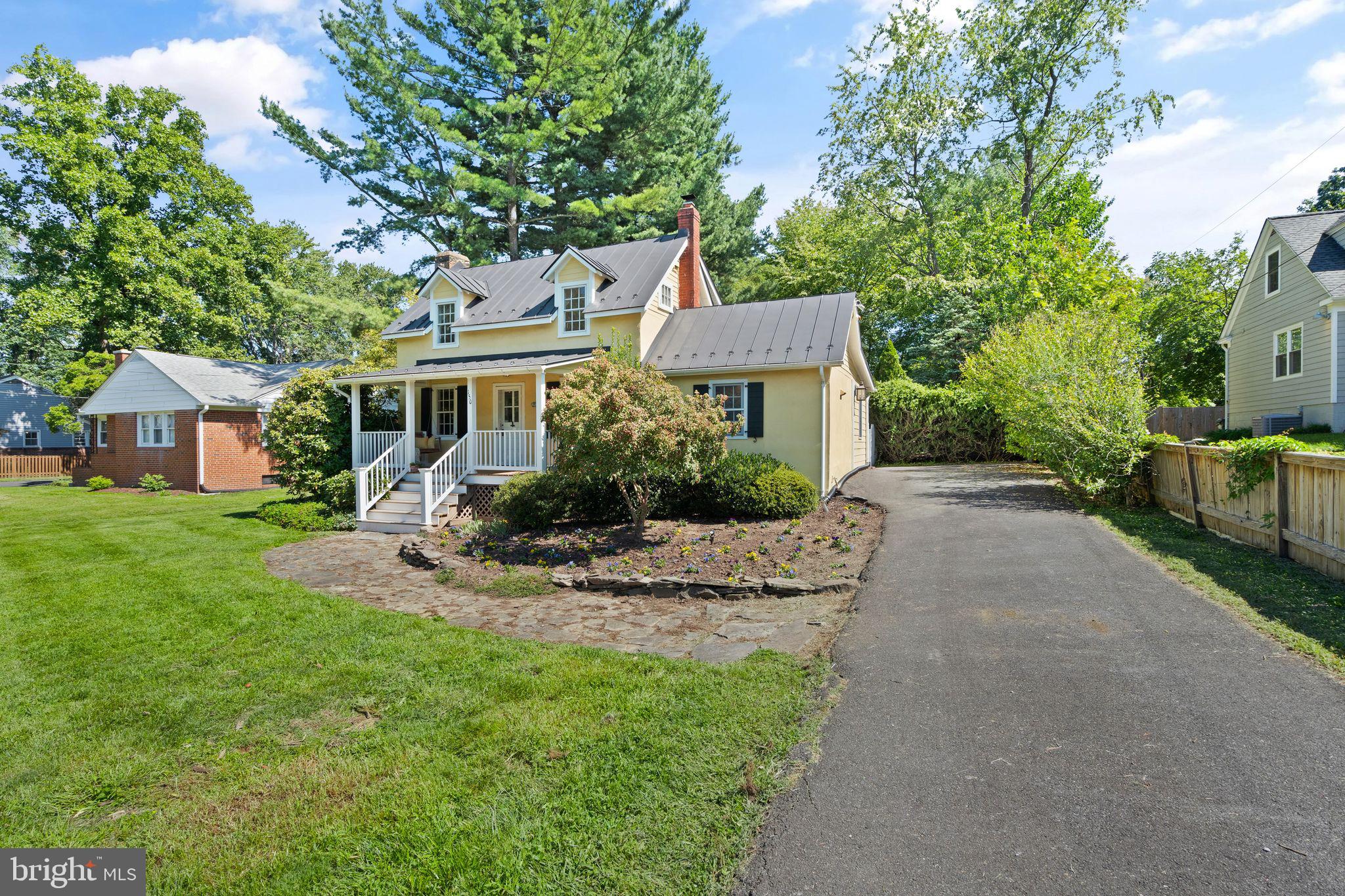 a front view of a house with a garden and porch