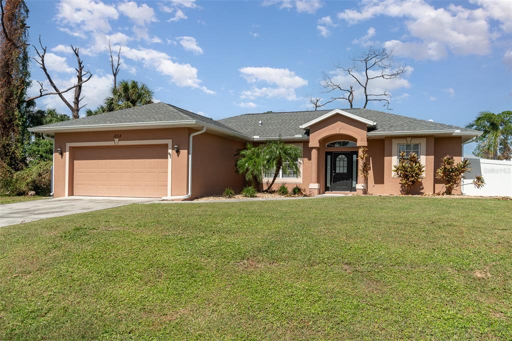 a front view of a house with garden