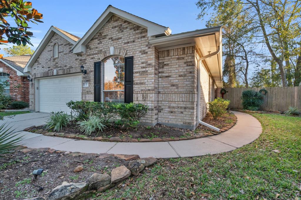 Front of home with curved sidewalk to entry