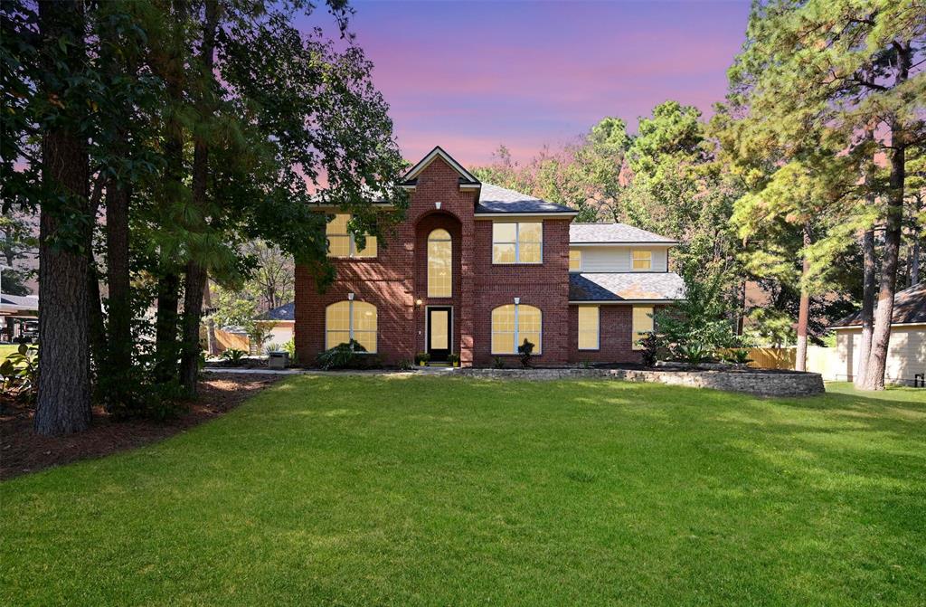 a view of a big yard with large trees