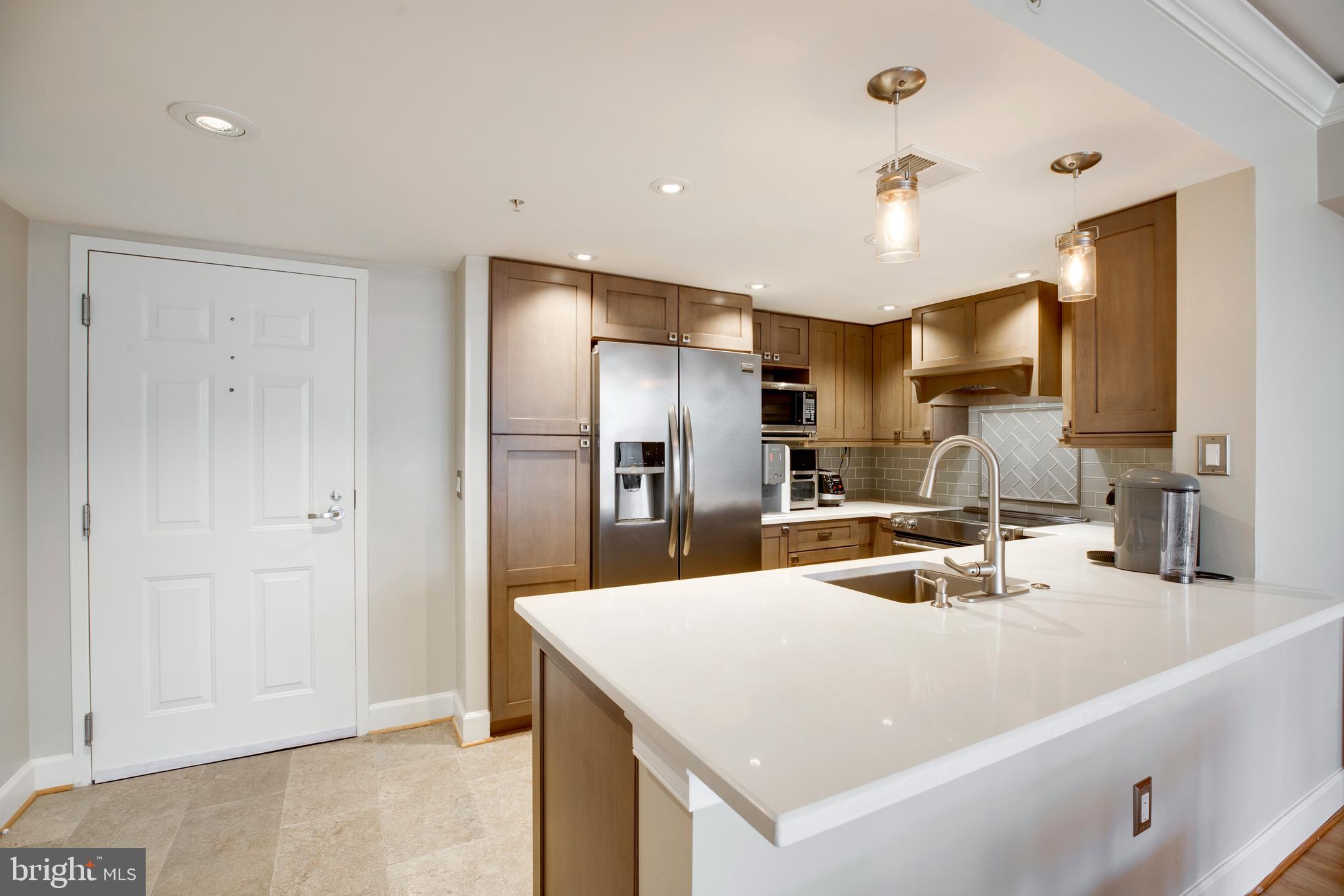 a kitchen with a refrigerator a sink and cabinets