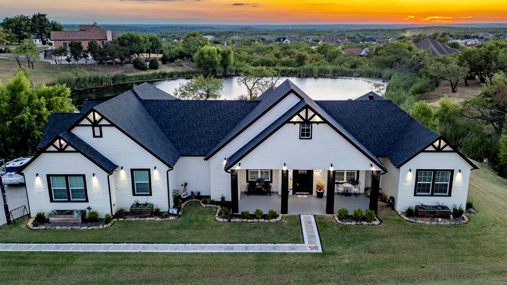 a aerial view of a house next to a yard