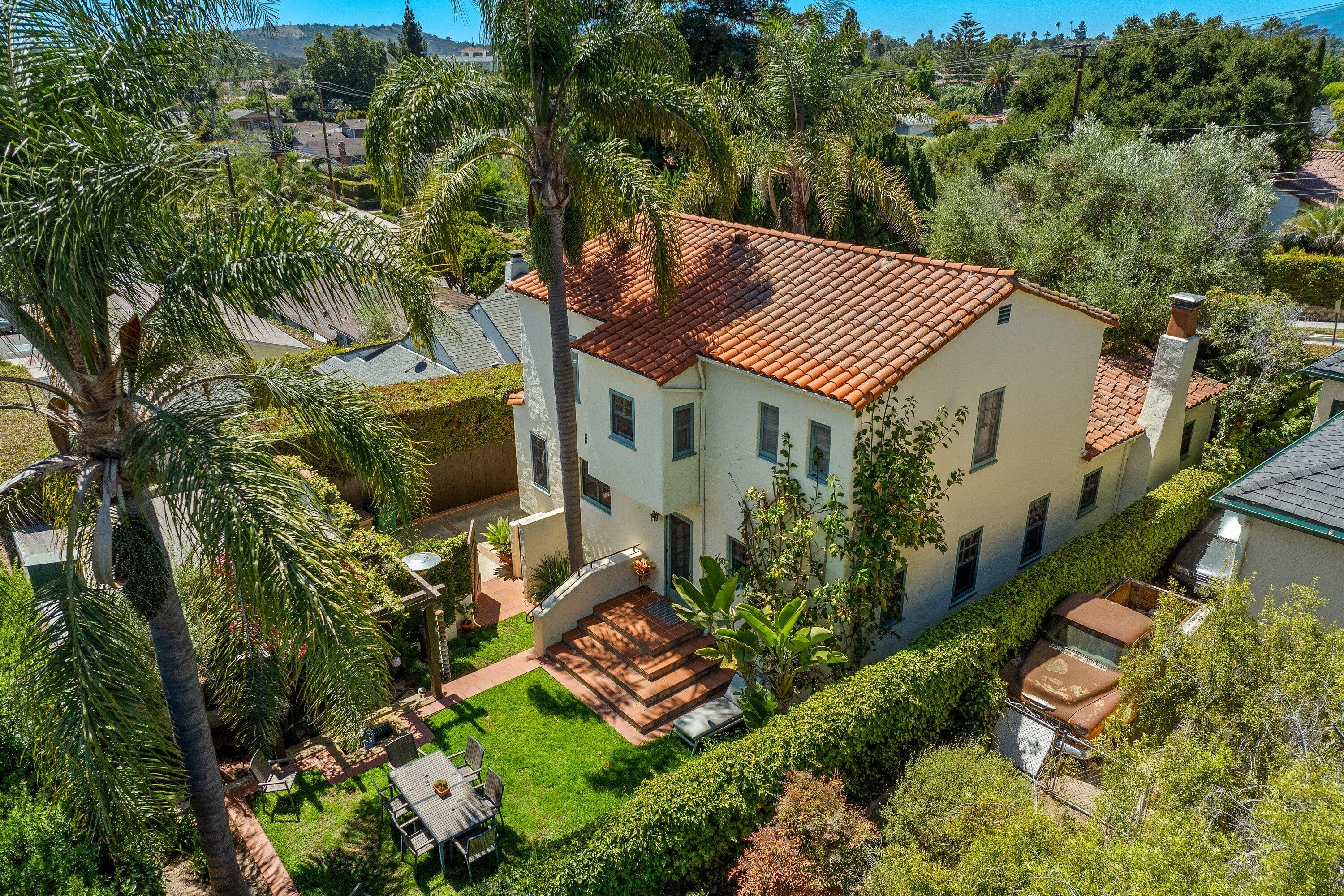 an aerial view of a house with a yard and garden