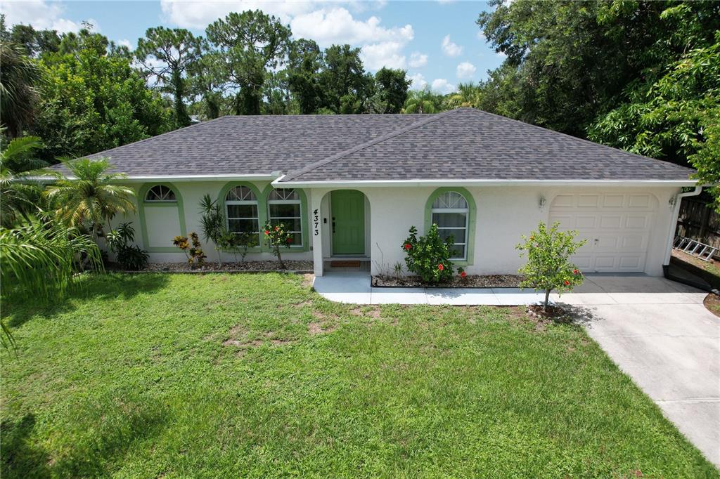 a view of a house with garden and yard