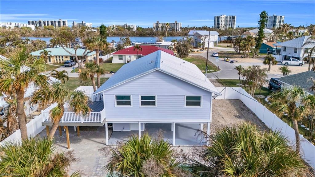 a aerial view of a house with a yard and lake view