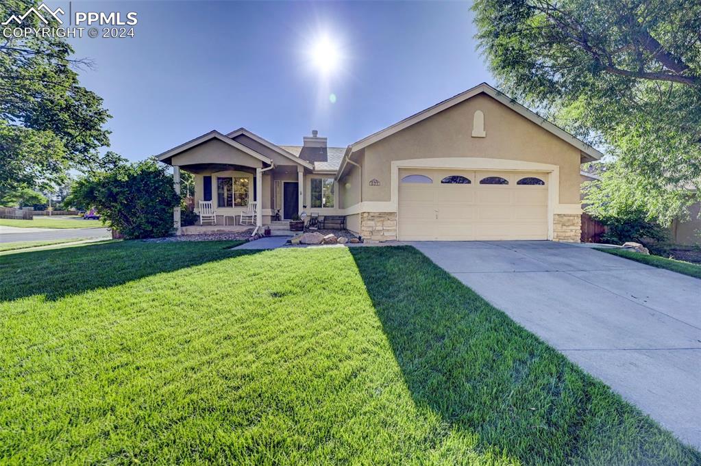 a front view of a house with a yard and garage