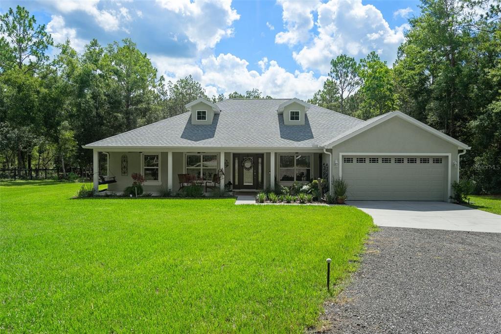 a front view of a house with a garden and porch