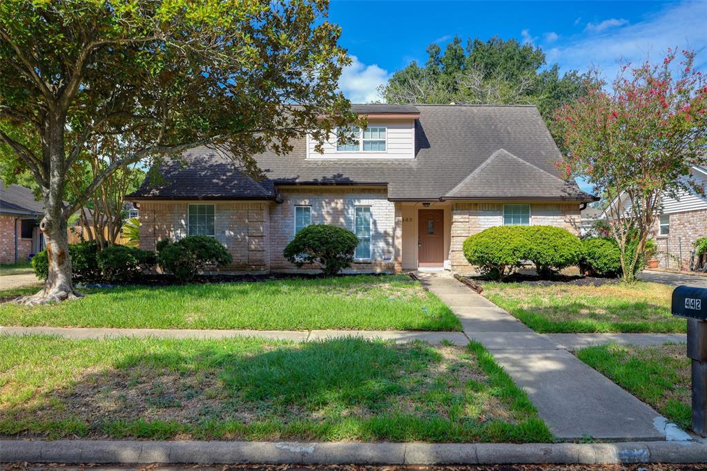 a front view of a house with a yard and a garage