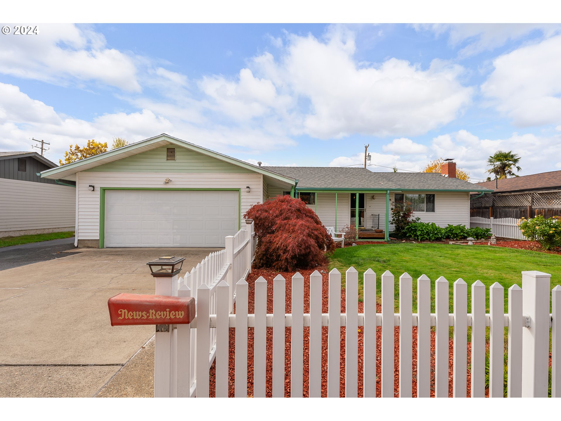 a front view of house with wooden fence