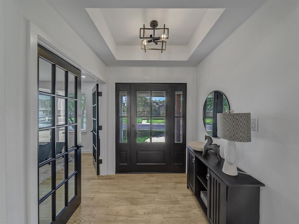 a view of a hallway with entryway wooden floor and front door