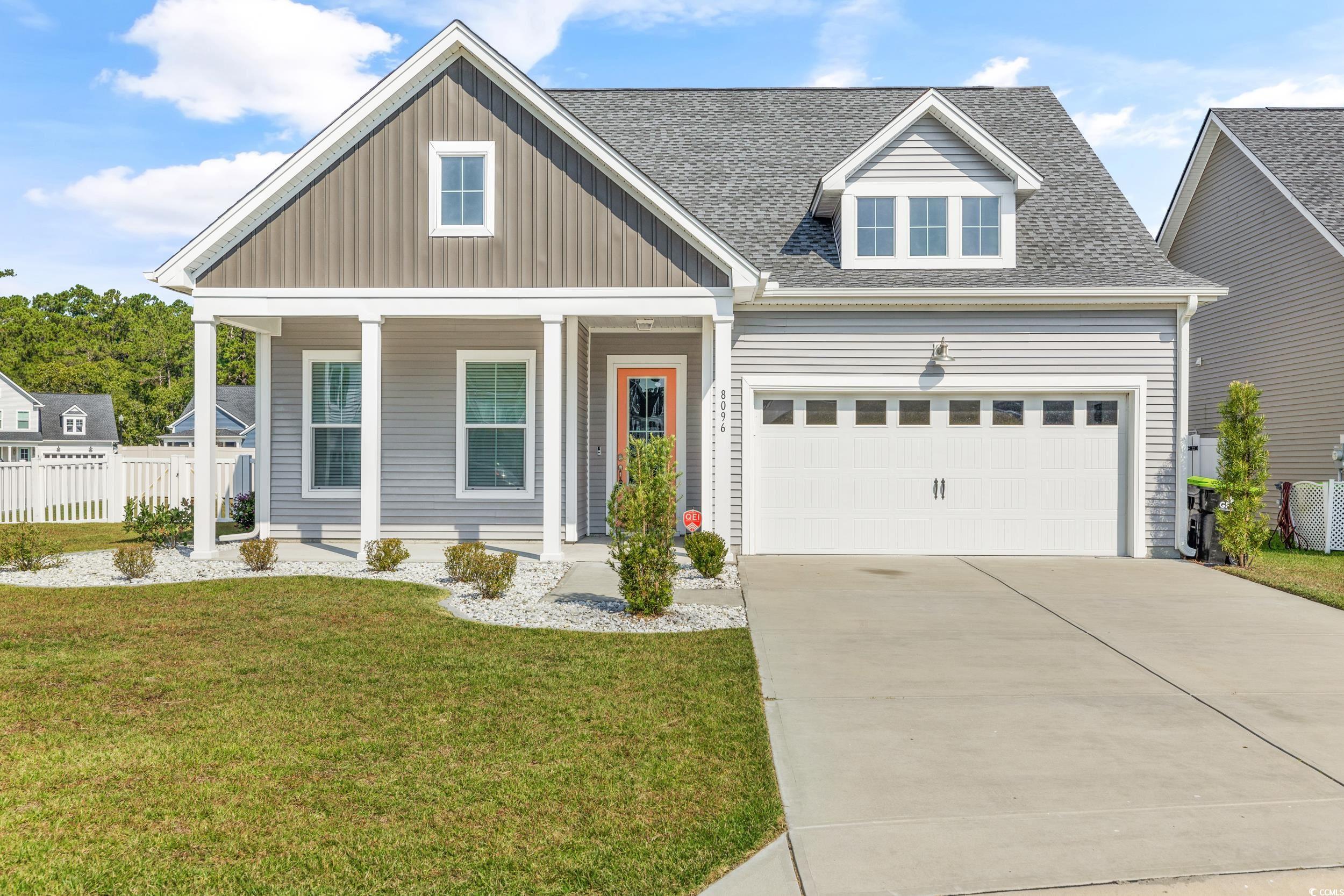 View of front of home with covered porch and a fro