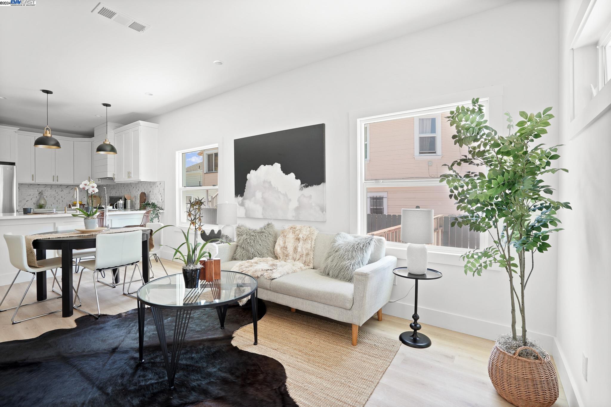 a living room with furniture and a potted plant