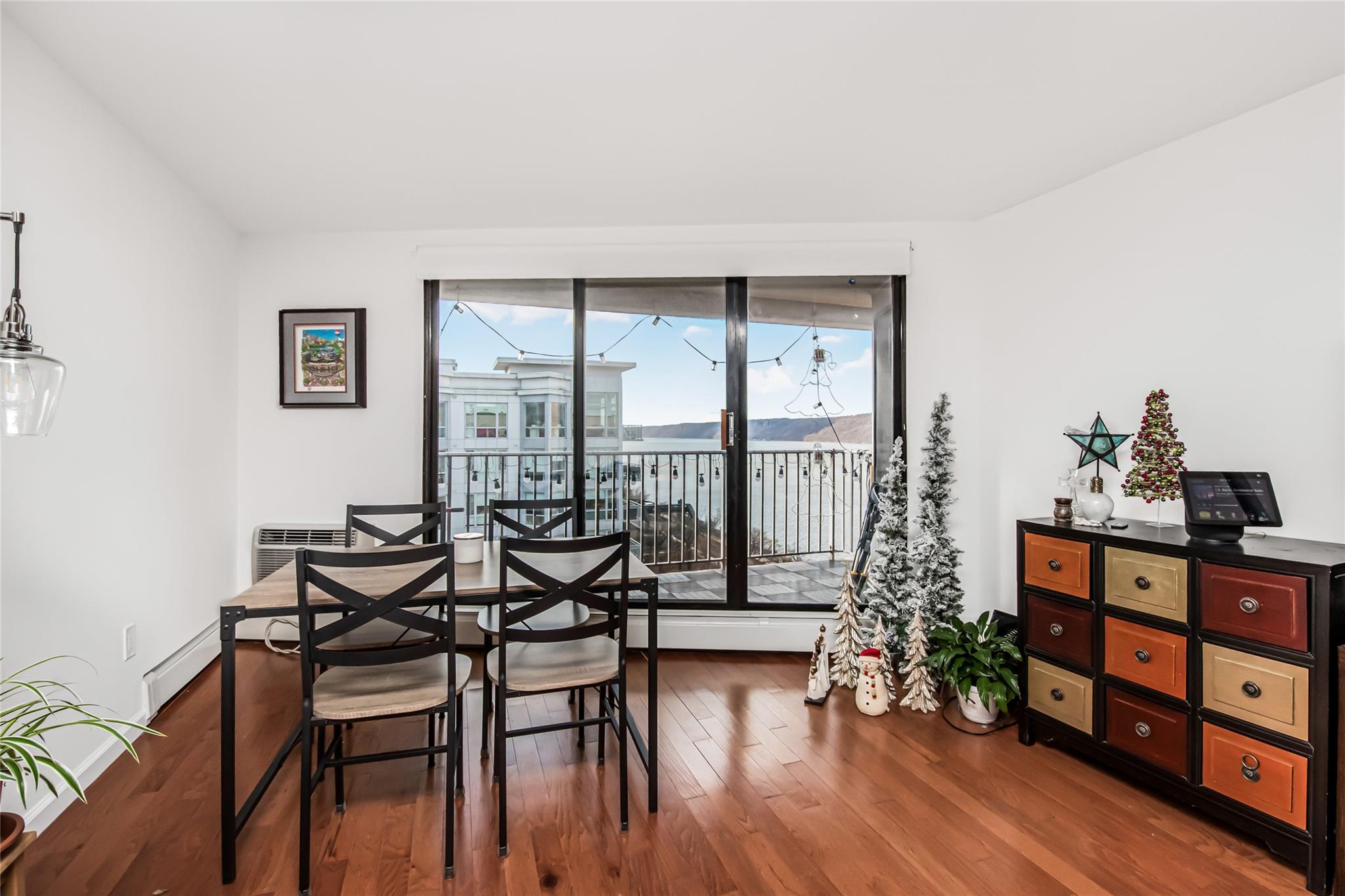 a dining room with furniture and wooden floor