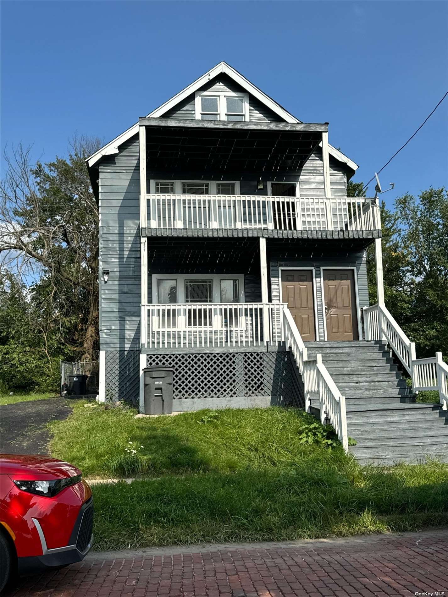 a front view of a house with a garden