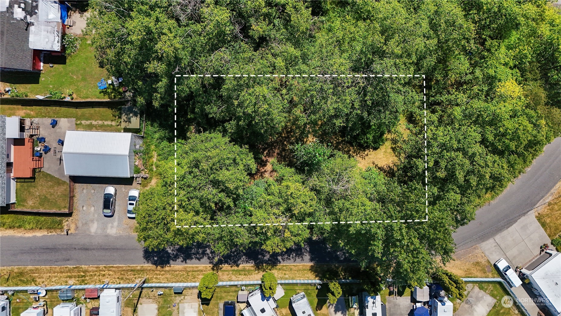 an aerial view of a house with a yard basket ball court and outdoor seating