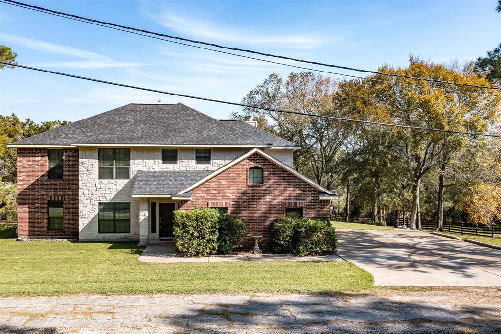 a front view of house with yard and garage