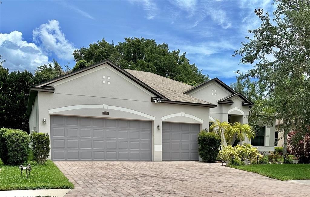 a front view of a house with a yard and garage