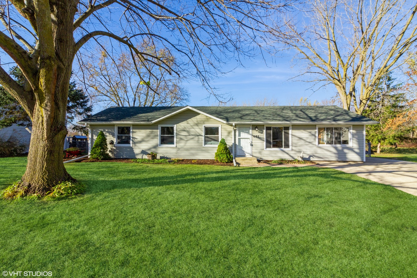 a front view of a house with a garden