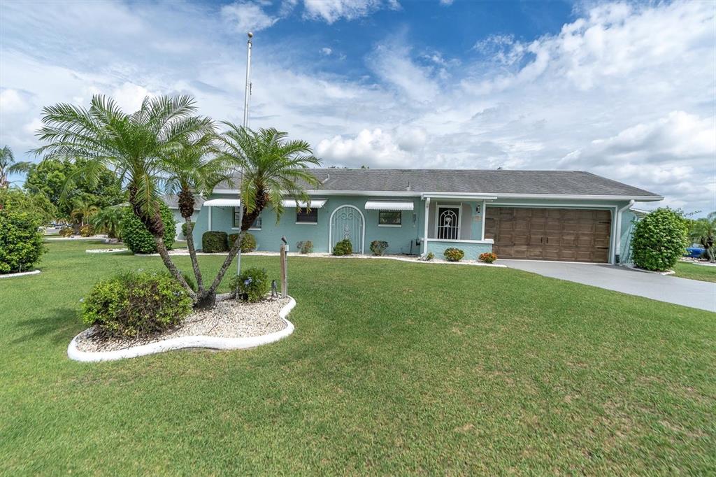 a front view of house with yard and green space