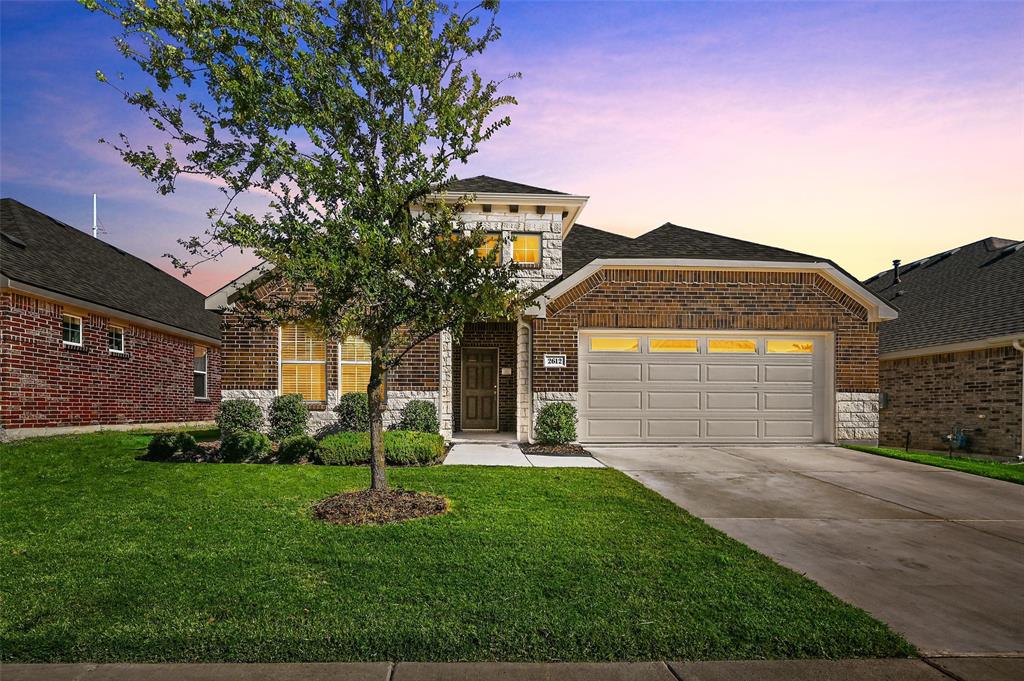 a front view of a house with a yard and garage