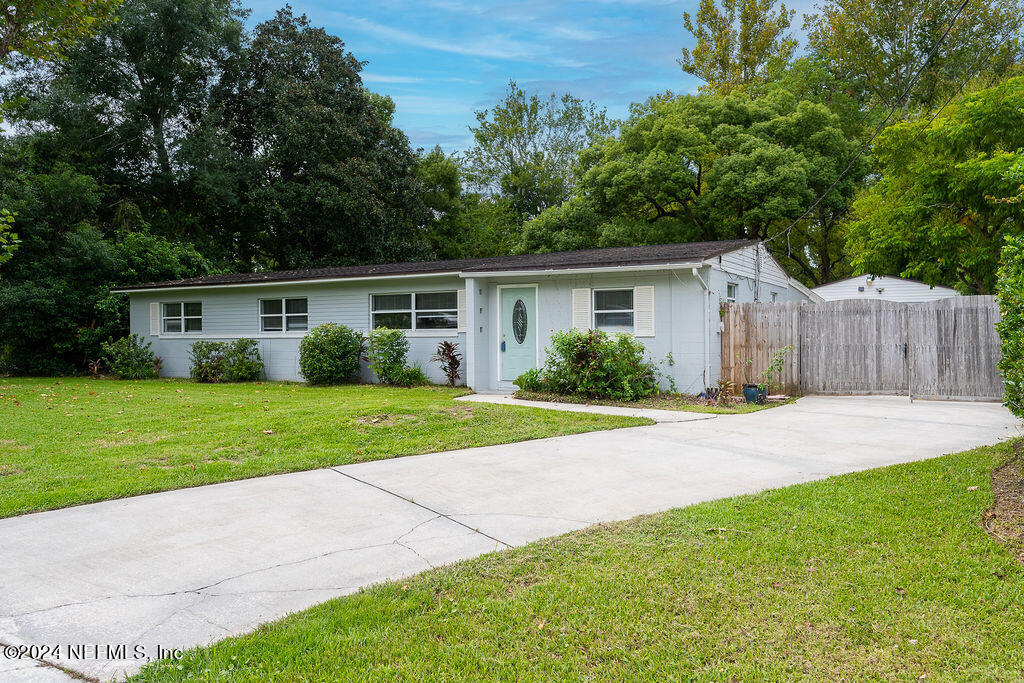 a view of a house with a yard and a garden