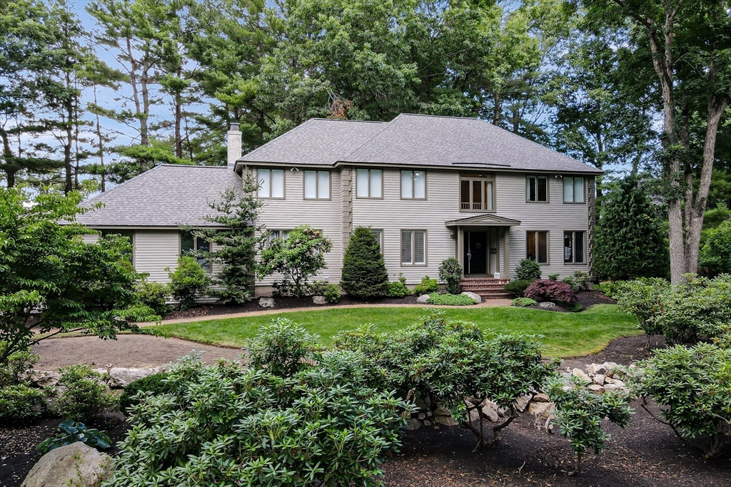 a view of a house with garden and yard