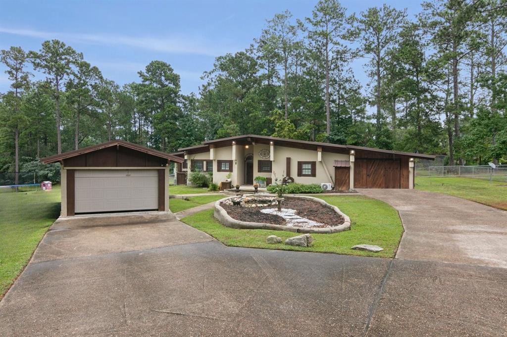 a front view of house with yard and green space