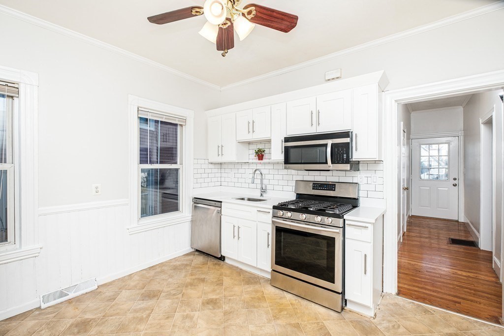 a kitchen with granite countertop a stove top oven and sink