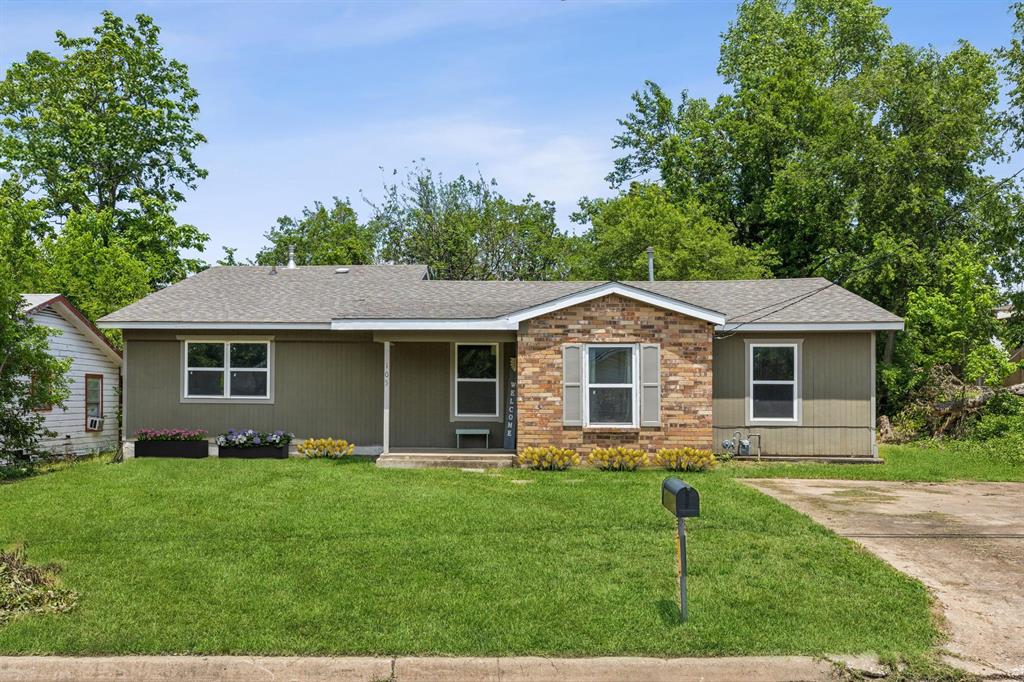 a front view of house with yard and green space