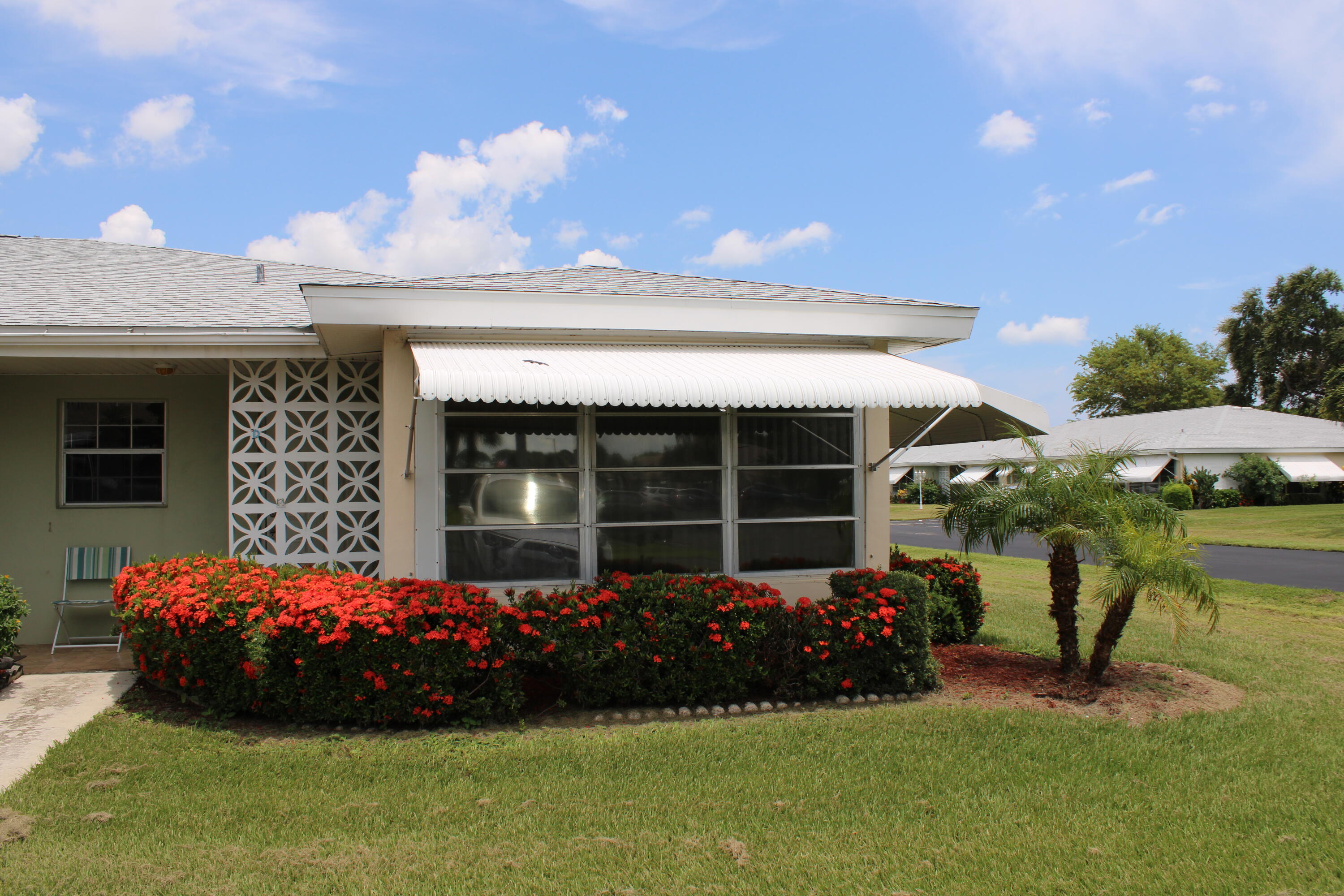 a front view of a house with a garden and porch