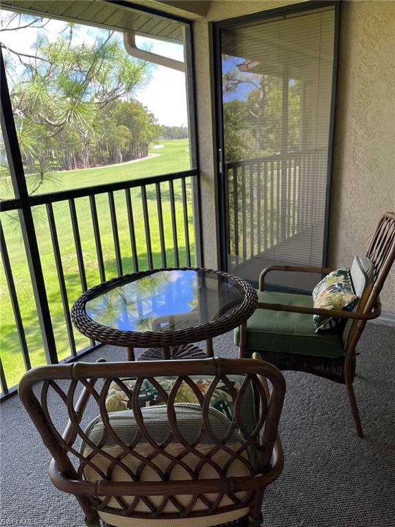 a view of a balcony with furniture