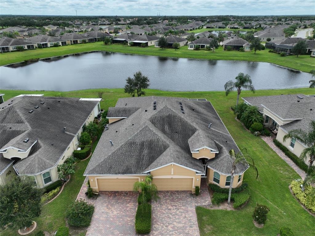 an aerial view of a house with a lake view