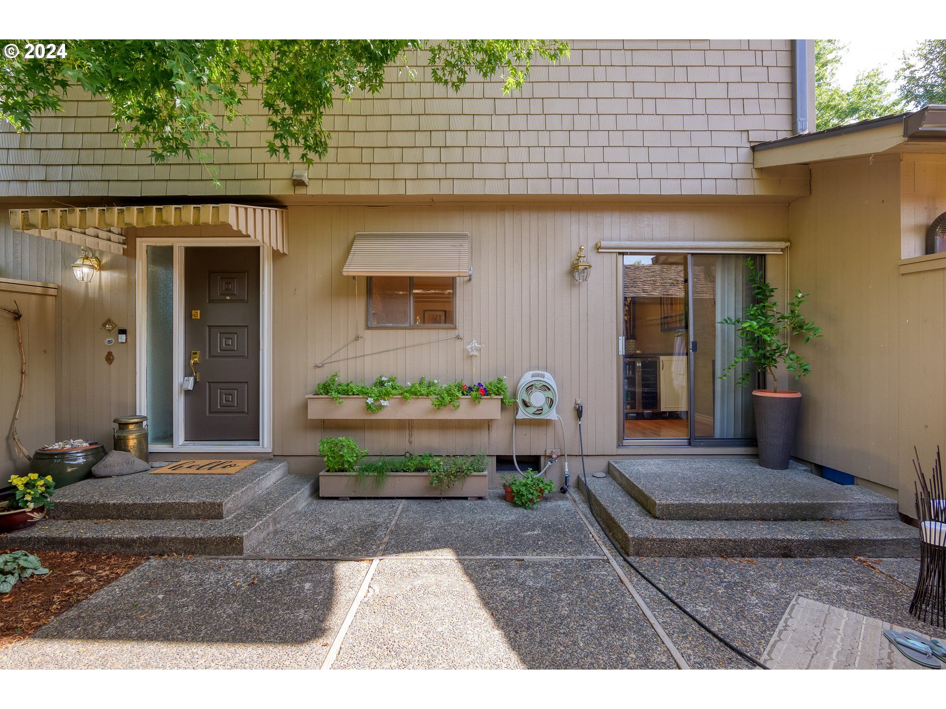 a front view of a house with garden