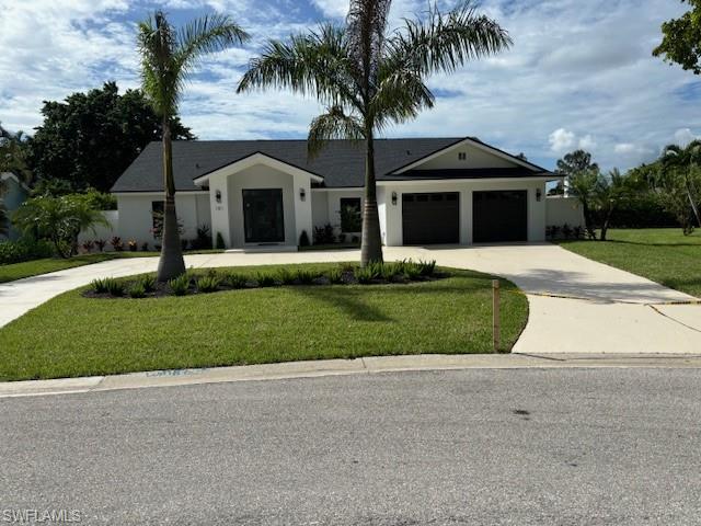 a front view of house with yard and green space